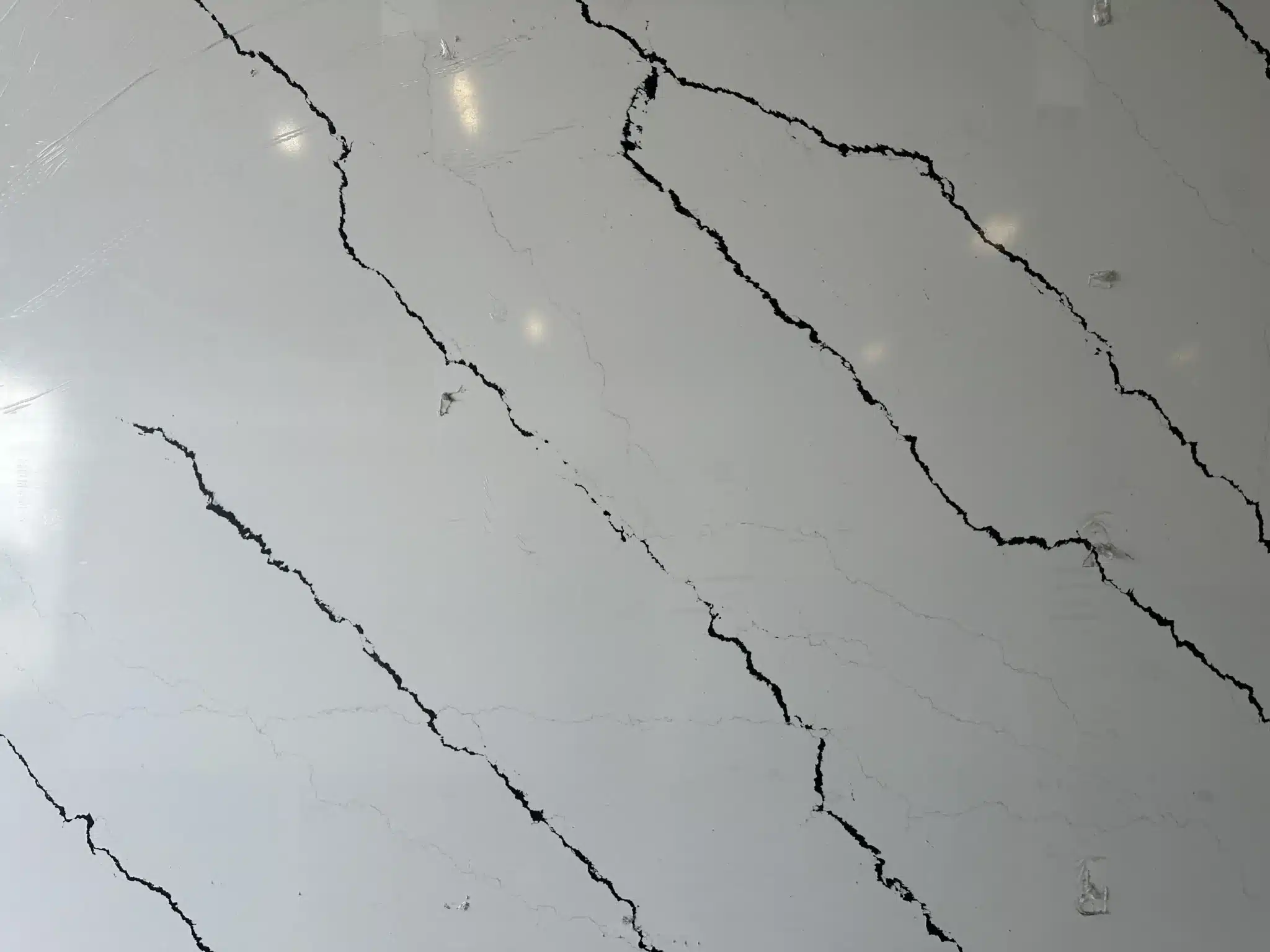Calacatta Panda slab with bold black and gray veining on a white surface