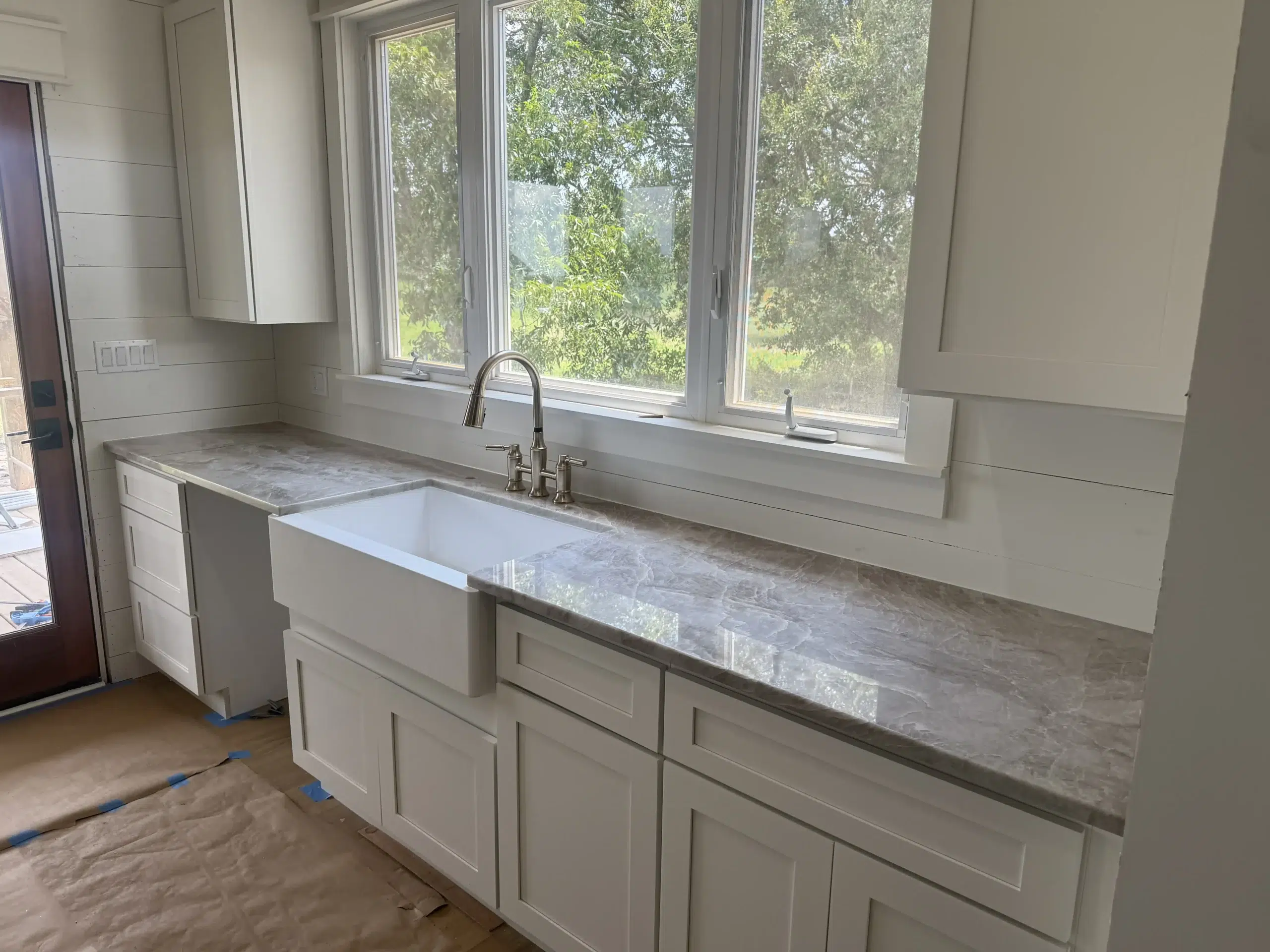 Looking for the latest 2026 kitchen trends? We specialize in honed and matte finish stone that reduces glare and hides fingerprints. Our team provides warm neutral quartz in taupe and greige, as well as earthy granite tones like olive and terracotta. We are experts in full-height slab backsplashes for a seamless, modern look, and curved countertop edges like Ogee and Bullnose that give your kitchen a bespoke furniture feel. Whether you want natural quartzite with dramatic veining or bespoke wood-tone cabinets with matching stone islands, we help you move beyond the sterile all-white look and into a more organic, high-end aesthetic."