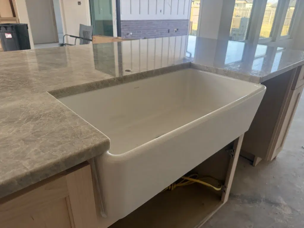 Taj Mahal Quartzite countertop island with farmhouse sink